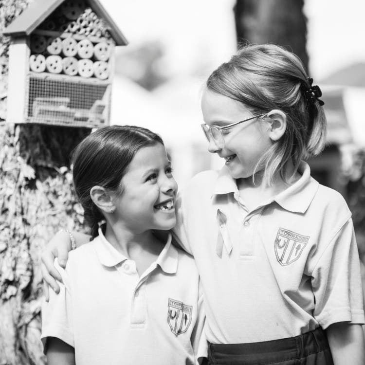 Students hugging and smiling at each other